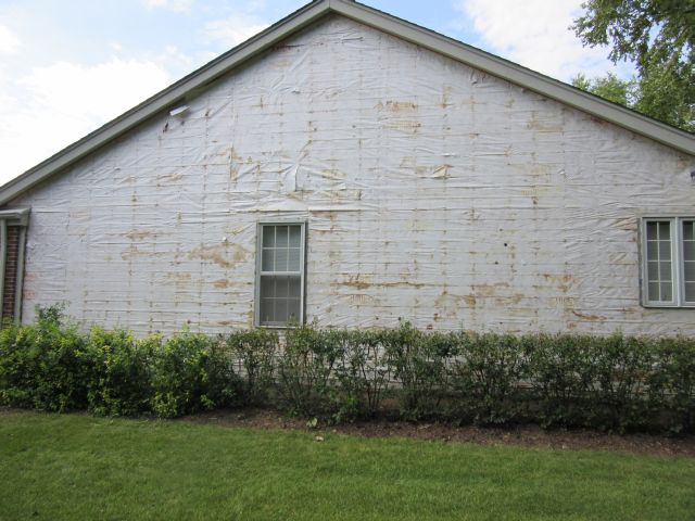 Failing, water-stained house wrap